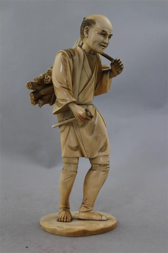 A Japanese sectional ivory figure of a farmer, 21.5cm